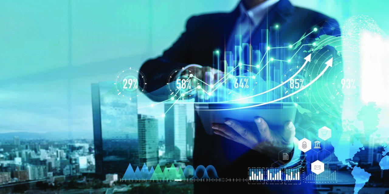 Digital marketing. Business strategy. Businessman using tablet analyzing sales data and economic growth graph chart on hologram screen. Business strategy and digital data.
